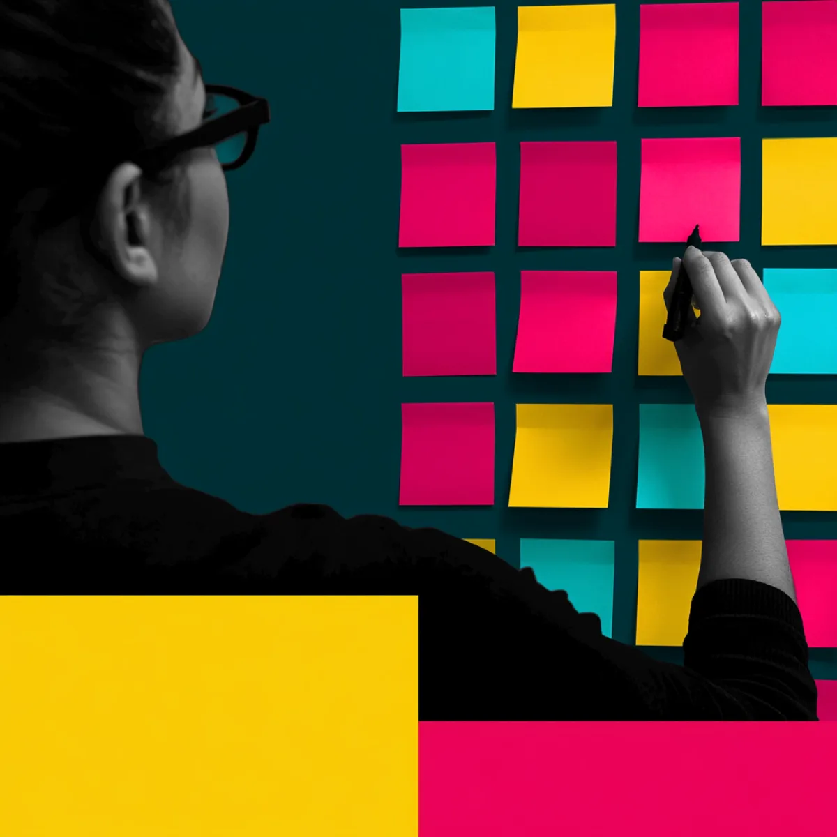 A developer mapping a build across a wall of coloured cards